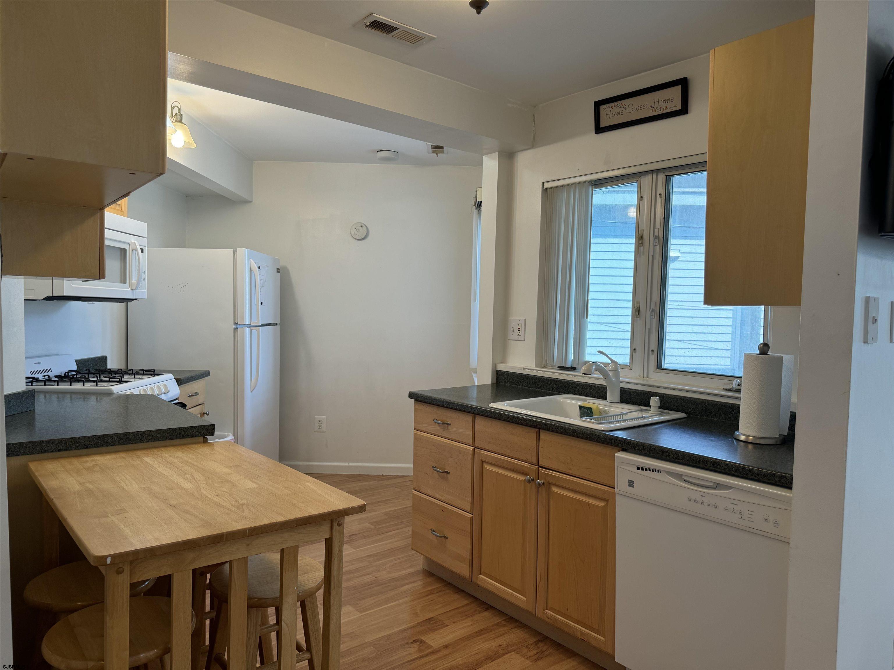 407 36th Street South, Unit 2 Brigantine, NJ 08203 - Photo 10 of 30 a kitchen with a stove a sink and a refrigerator