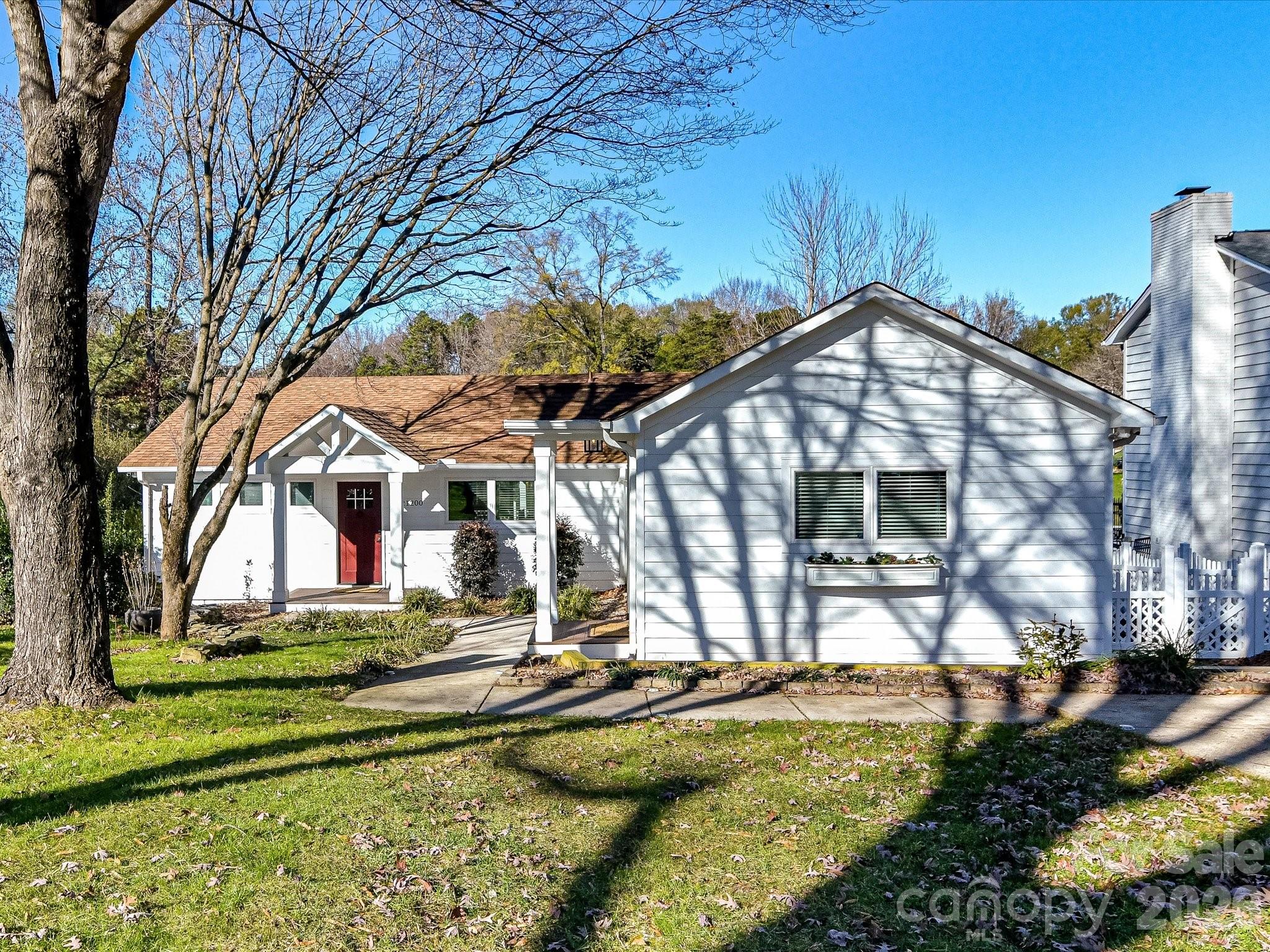 a view of a house with yard and sitting area