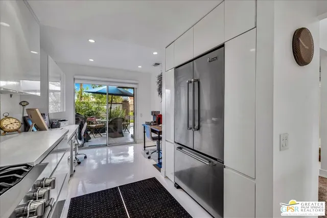 a kitchen with stainless steel appliances granite countertop a refrigerator and a stove top oven