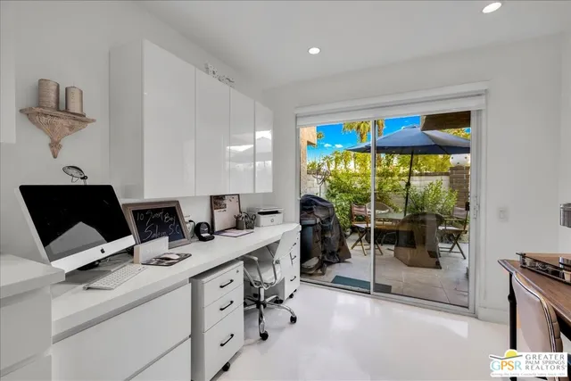 a view of kitchen with stainless steel appliances dining table and chairs