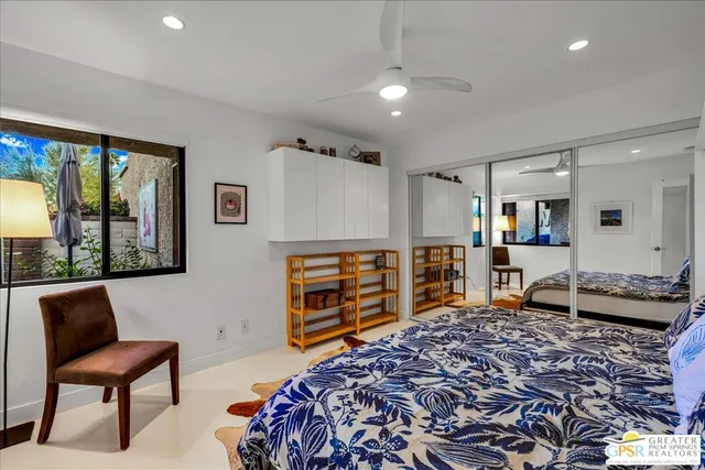 a bedroom with furniture and a window