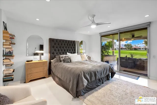 a spacious bedroom with a large bed and a large window