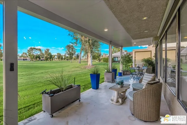 a room with furniture and a garden