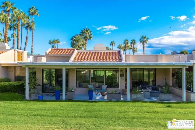 a view of a house with a backyard porch and sitting area