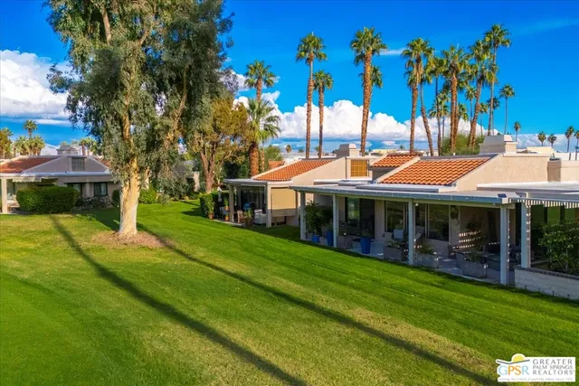 a view of a house with a backyard porch and sitting area