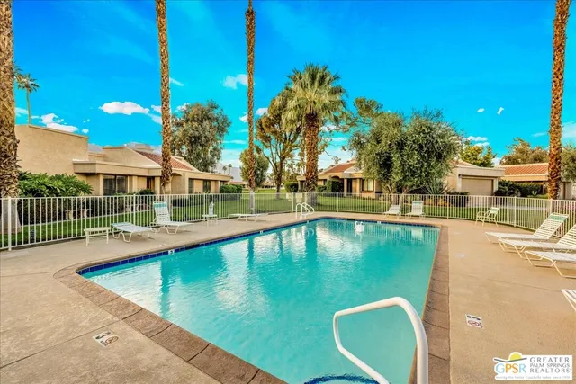 a view of a swimming pool with outdoor seating