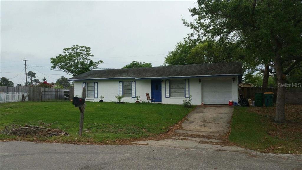2129 Trieste Drive Mims, FL 32754 - Photo 1 of 1 a front view of a house with a yard and garage