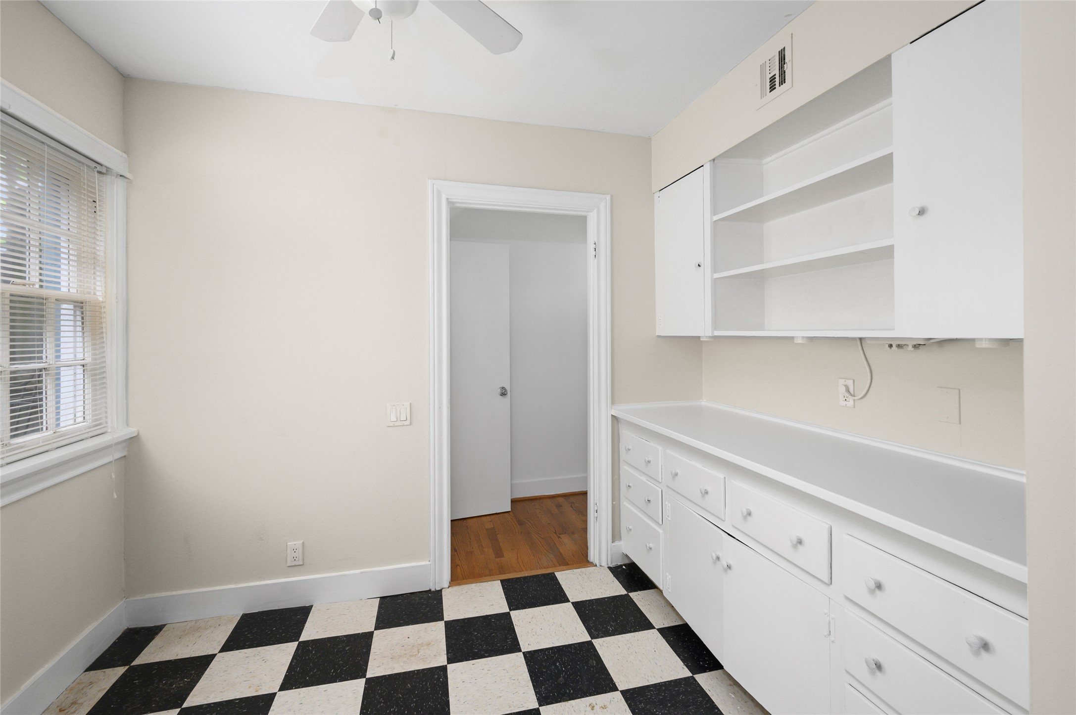 1955 Lexington Street Houston, TX 77098 - Photo 9 of 12 a room with a black white checkered floor with a black white checkered floor