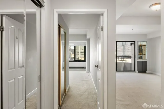 a view of a hallway with wooden shelves