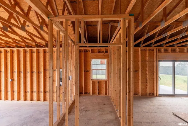 a view of a hallway with wooden floor and cabinet