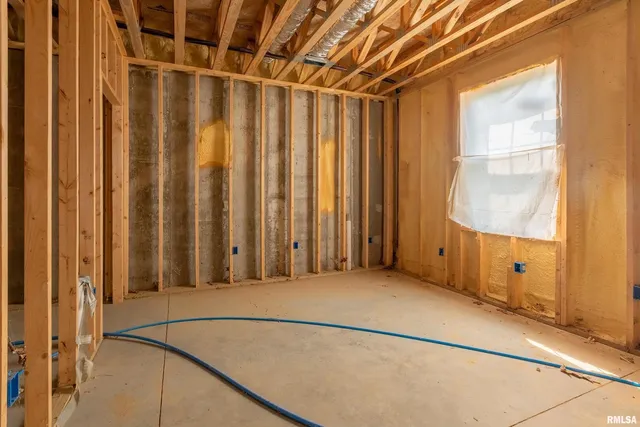 a aerial view of a house with a yard table and chairs