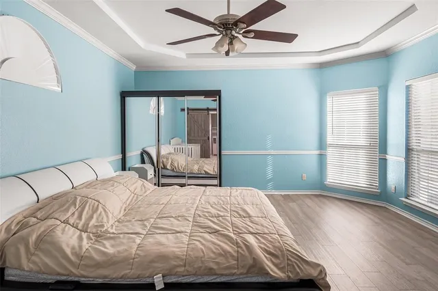 a bedroom with a large bed and a chandelier