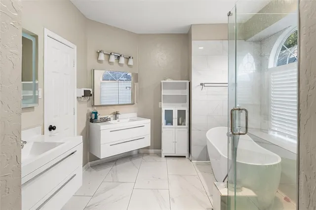 a bathroom with a bathtub and shower