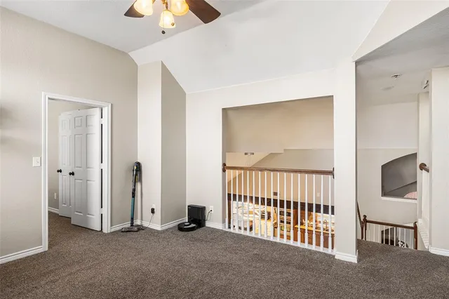 a view of a hallway with a livingroom and entryway