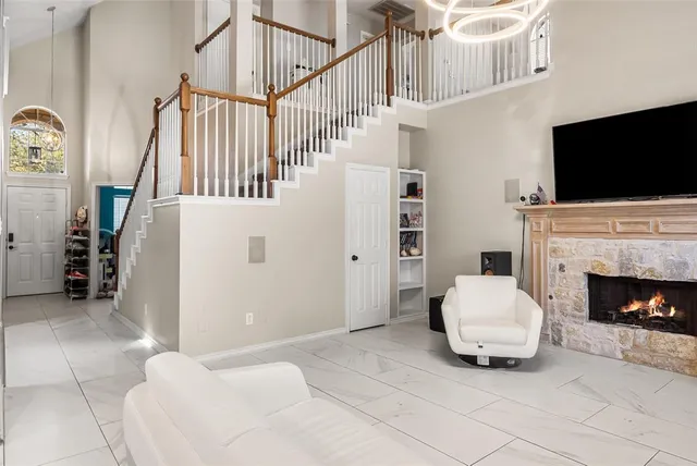 a living room with furniture a flat screen tv and a fireplace