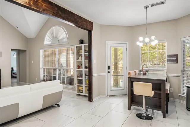 a living room with furniture and a chandelier