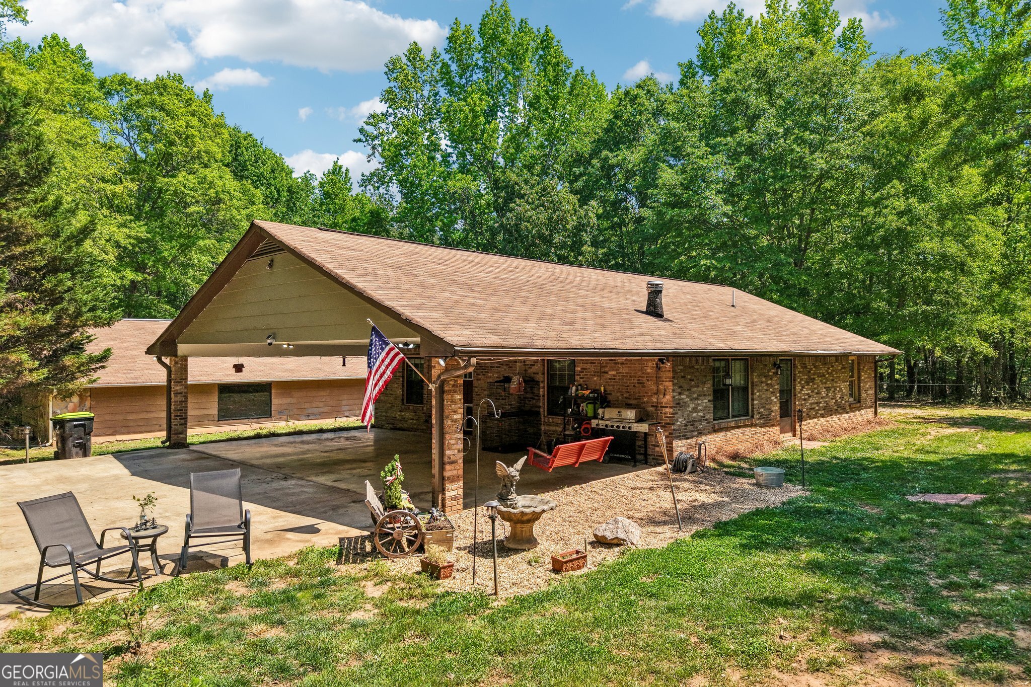 241 Busbin Road Fayetteville, GA 30215 - Photo 2 of 45 a view of a patio with table and chairs under an umbrella