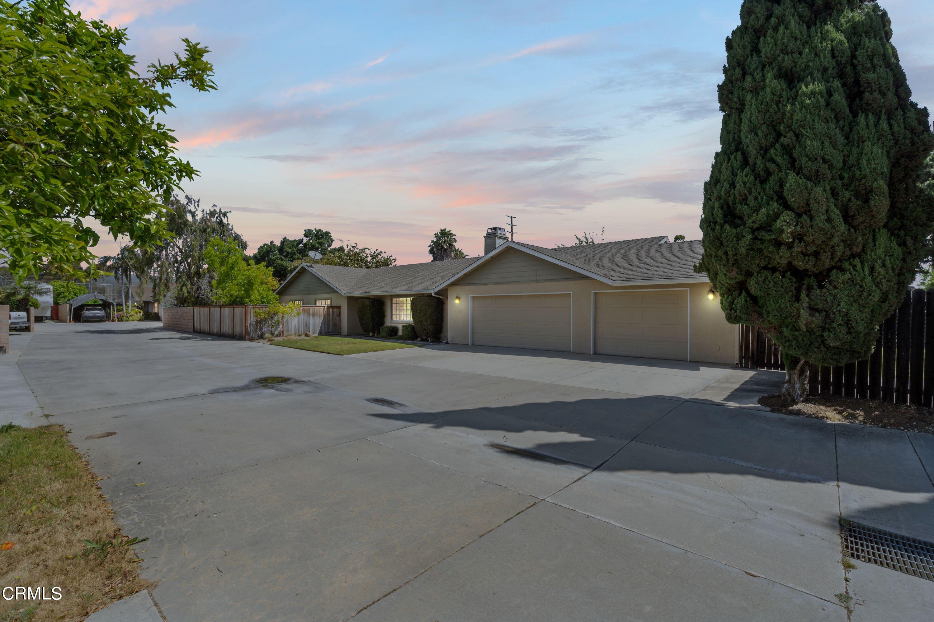 10975 Darling Road Ventura, CA 93004 - Photo 1 of 49 a front view of a house with a yard and garage