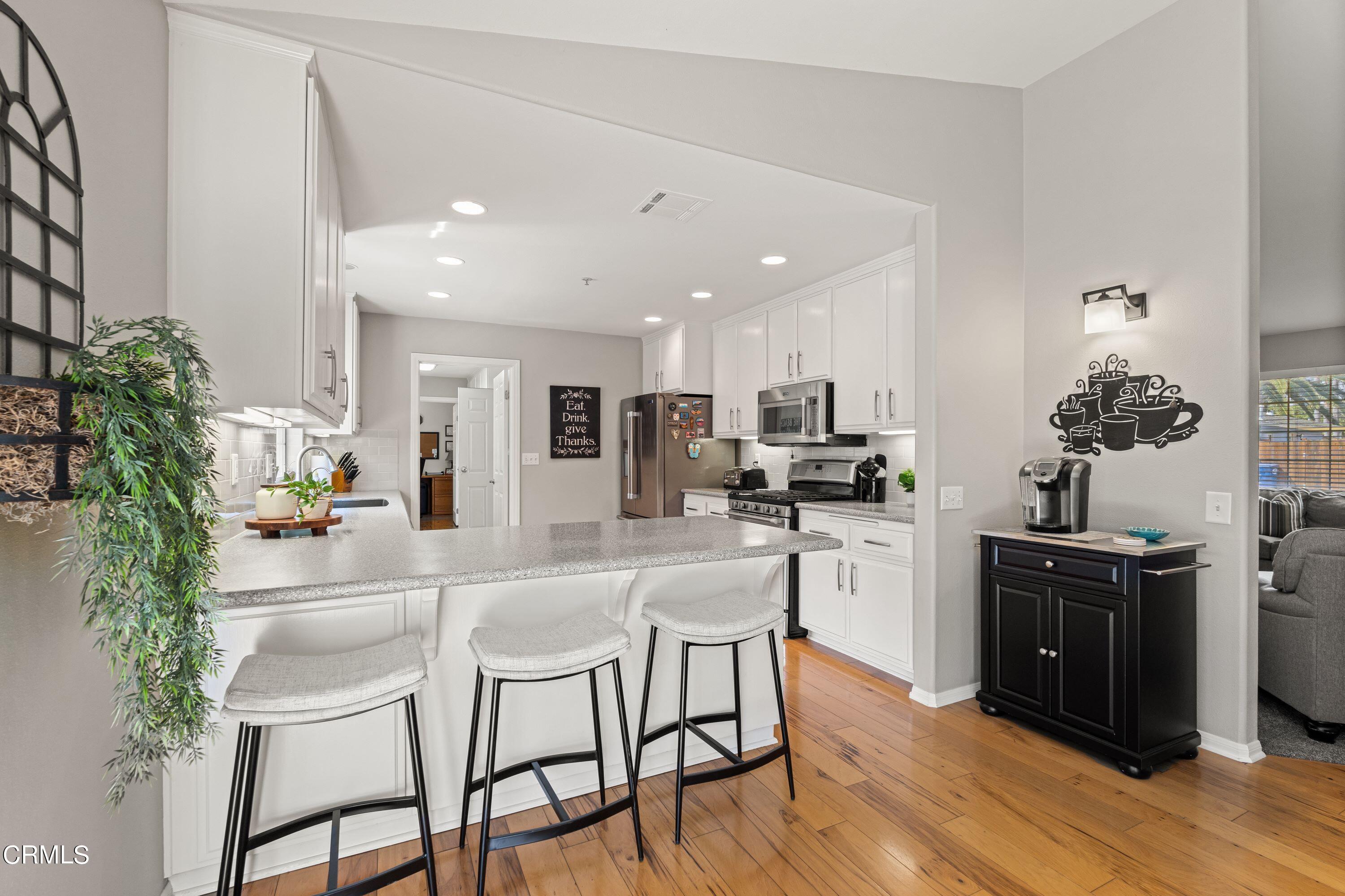10975 Darling Road Ventura, CA 93004 - Photo 13 of 49 a kitchen with refrigerator a sink and chairs