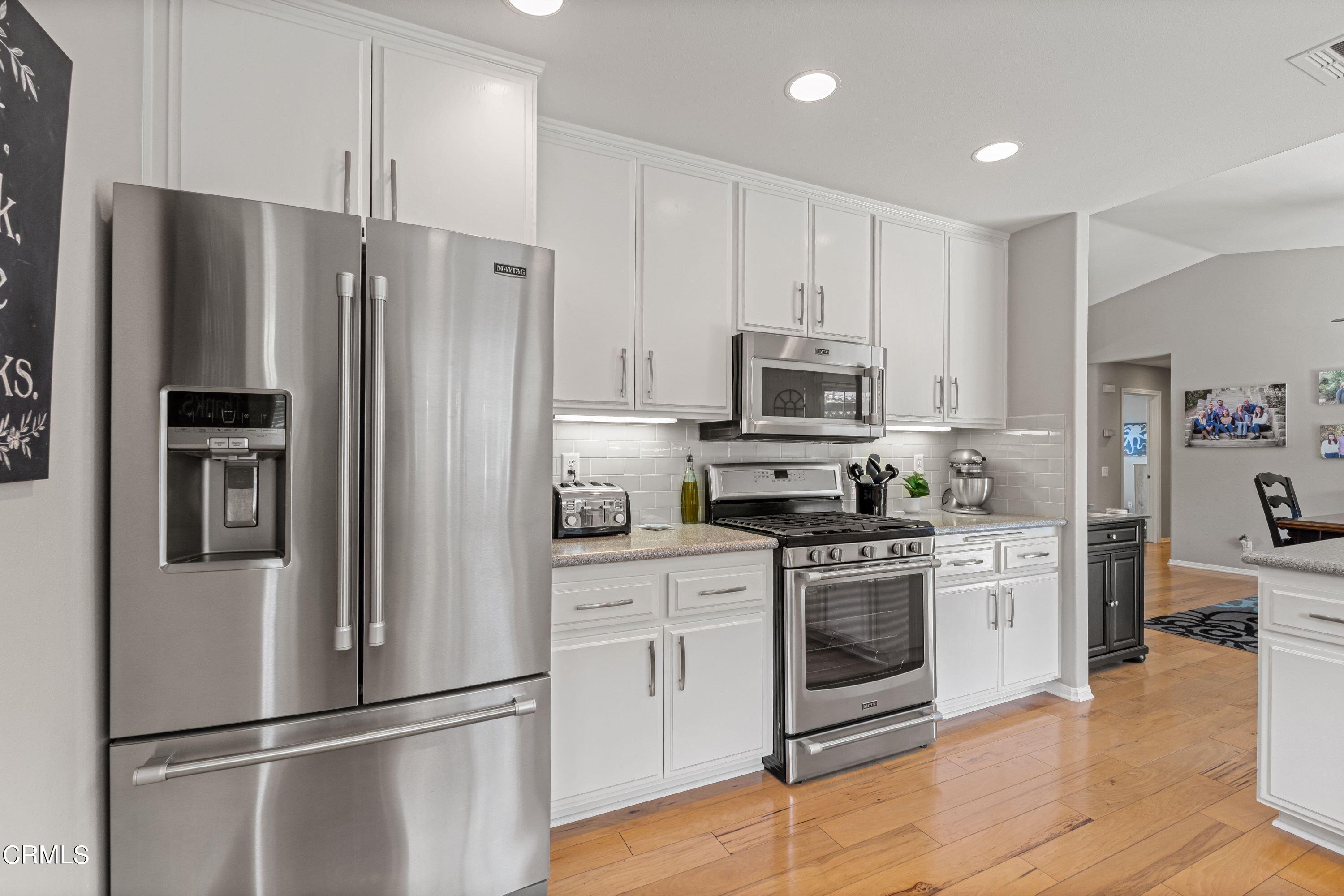 10975 Darling Road Ventura, CA 93004 - Photo 14 of 49 a kitchen with stainless steel appliances a refrigerator a stove top oven a sink and cabinets