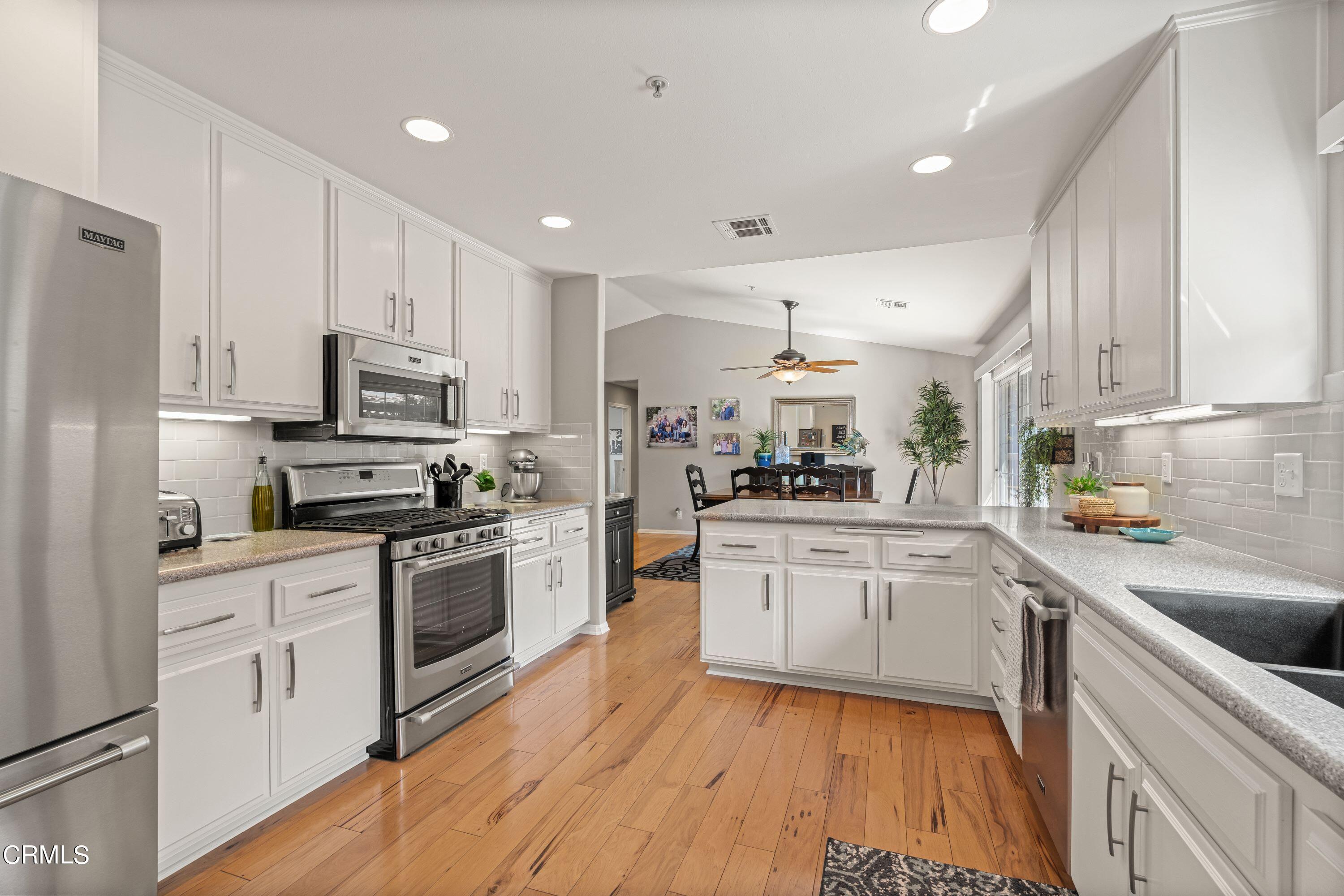 10975 Darling Road Ventura, CA 93004 - Photo 16 of 49 a kitchen with granite countertop white cabinets and white appliances