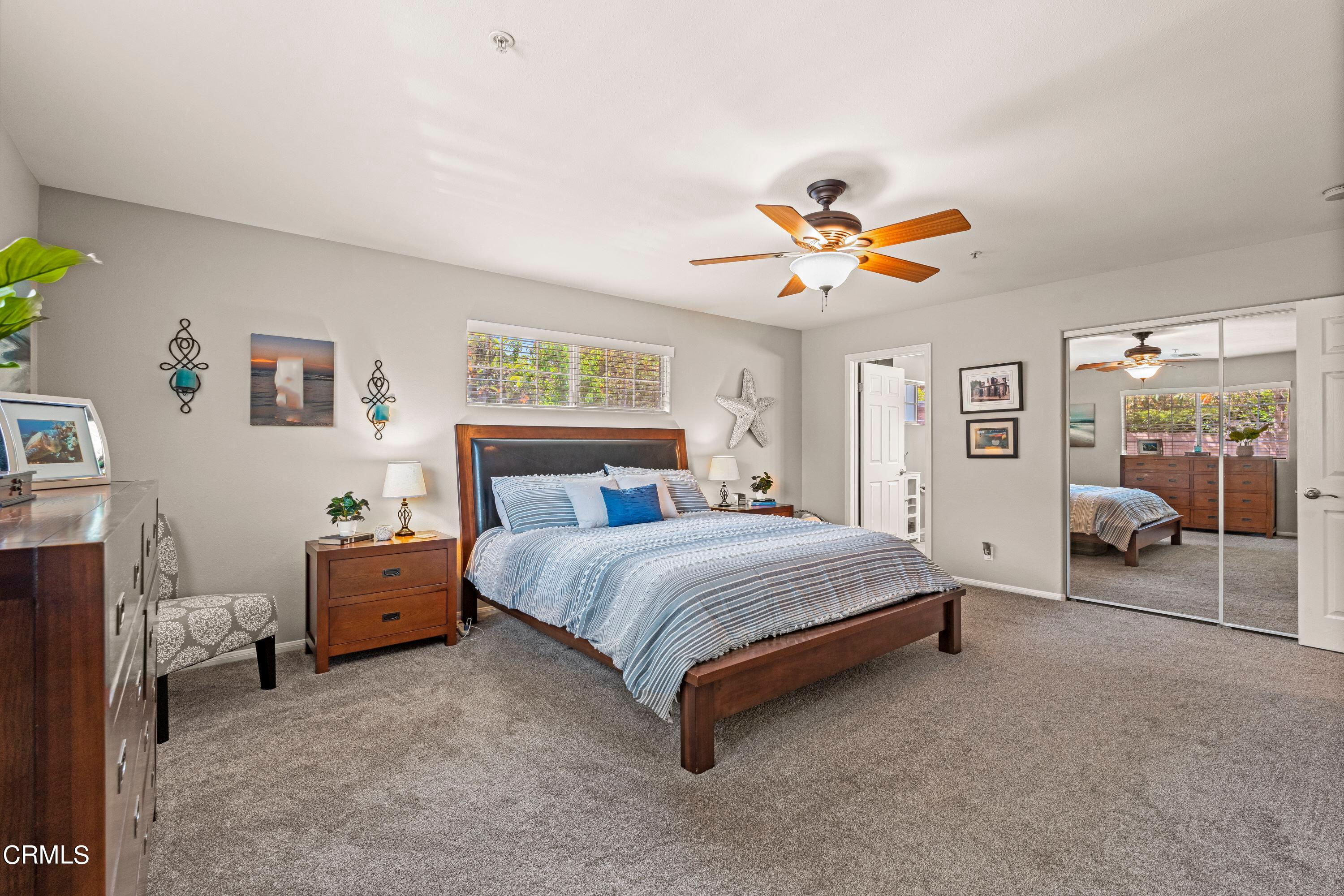 10975 Darling Road Ventura, CA 93004 - Photo 17 of 49 a spacious bedroom with a bed and a chandelier