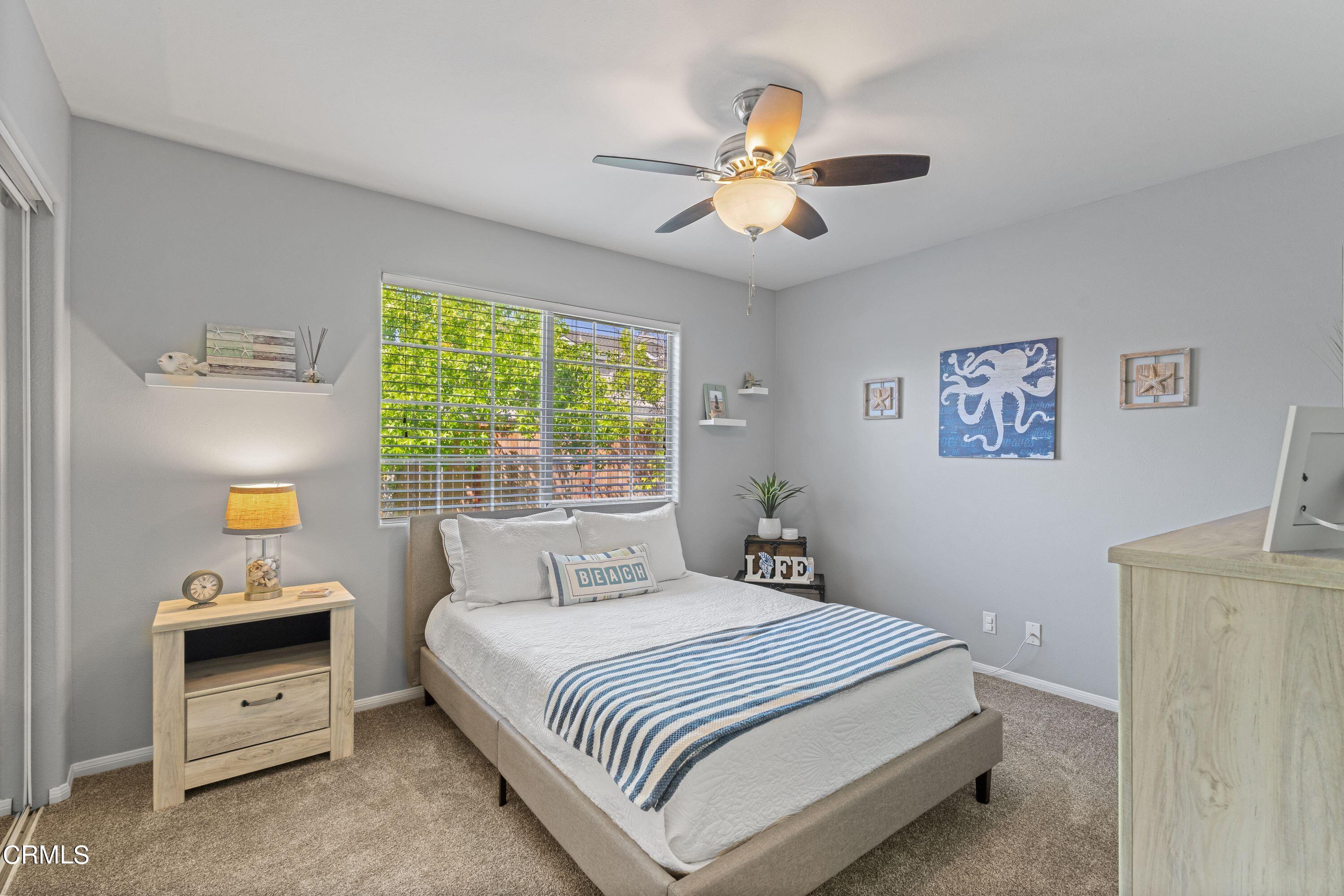 10975 Darling Road Ventura, CA 93004 - Photo 23 of 49 a bedroom with a bed and a chandelier