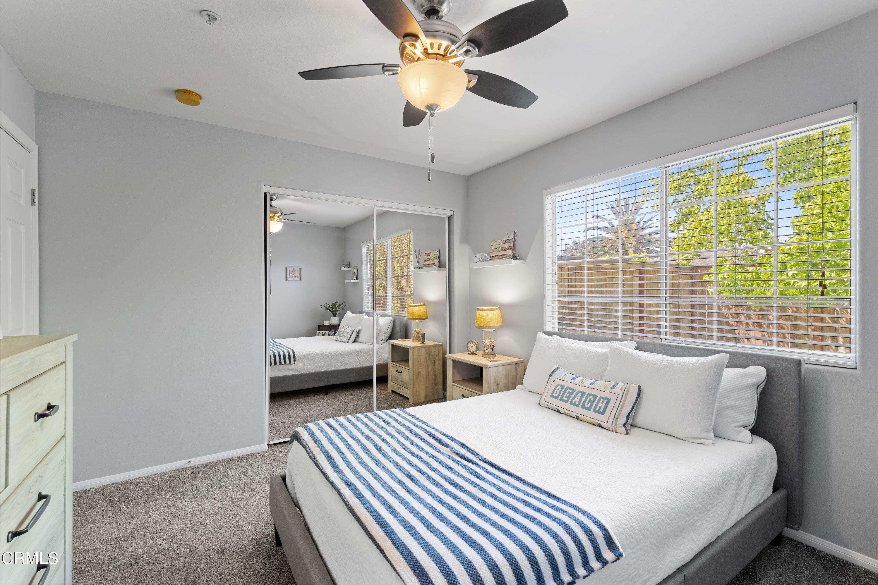 10975 Darling Road Ventura, CA 93004 - Photo 24 of 49 a bedroom with a bed and a chandelier