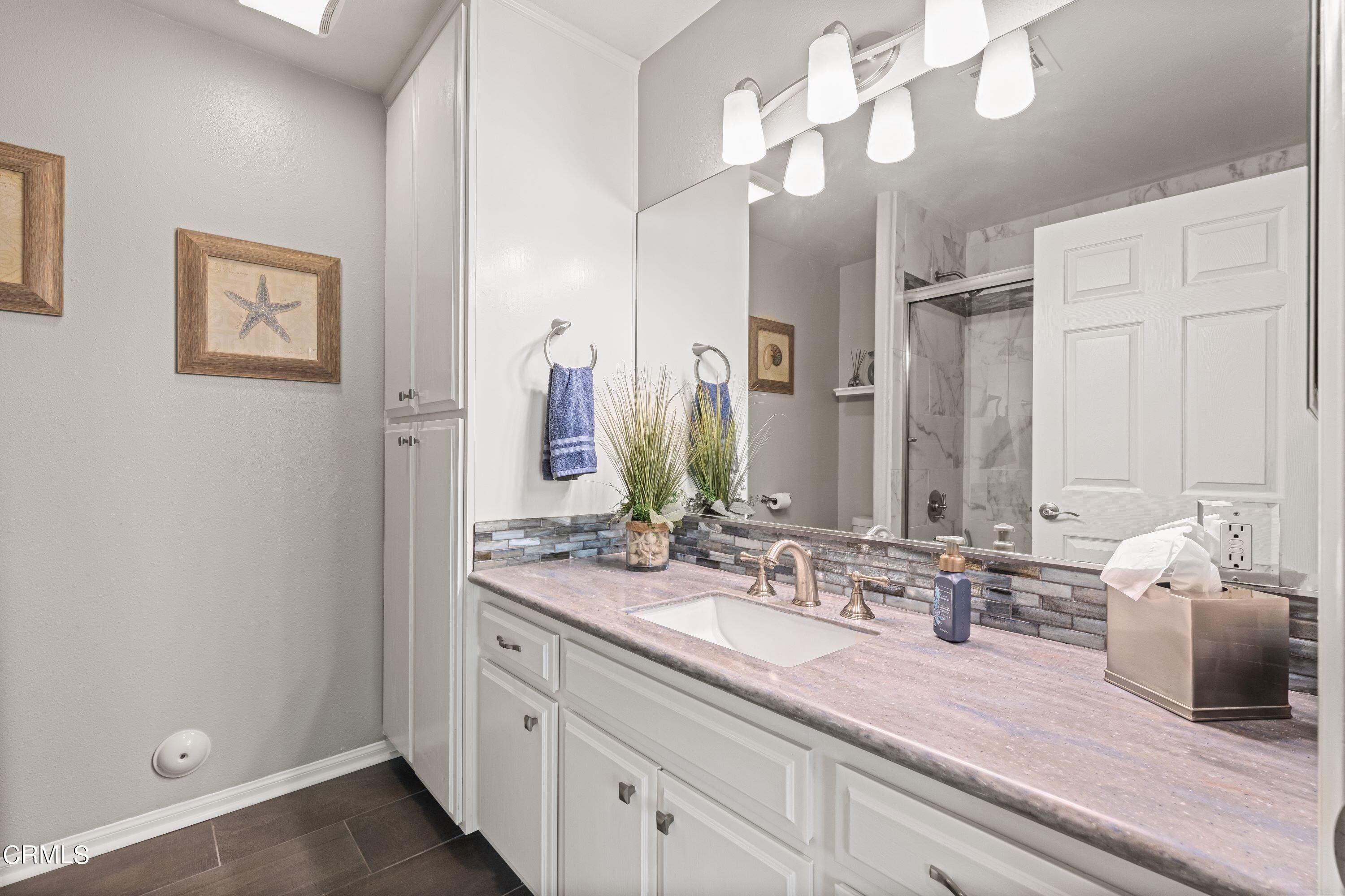 10975 Darling Road Ventura, CA 93004 - Photo 26 of 49 a bathroom with double vanity sinks a vanity and a large mirror