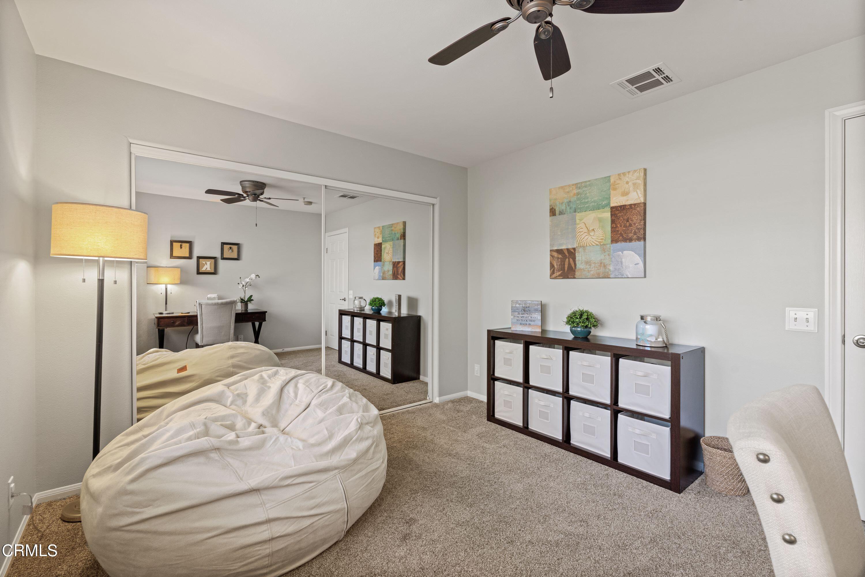 10975 Darling Road Ventura, CA 93004 - Photo 29 of 49 a spacious bedroom with a bed and a chandelier