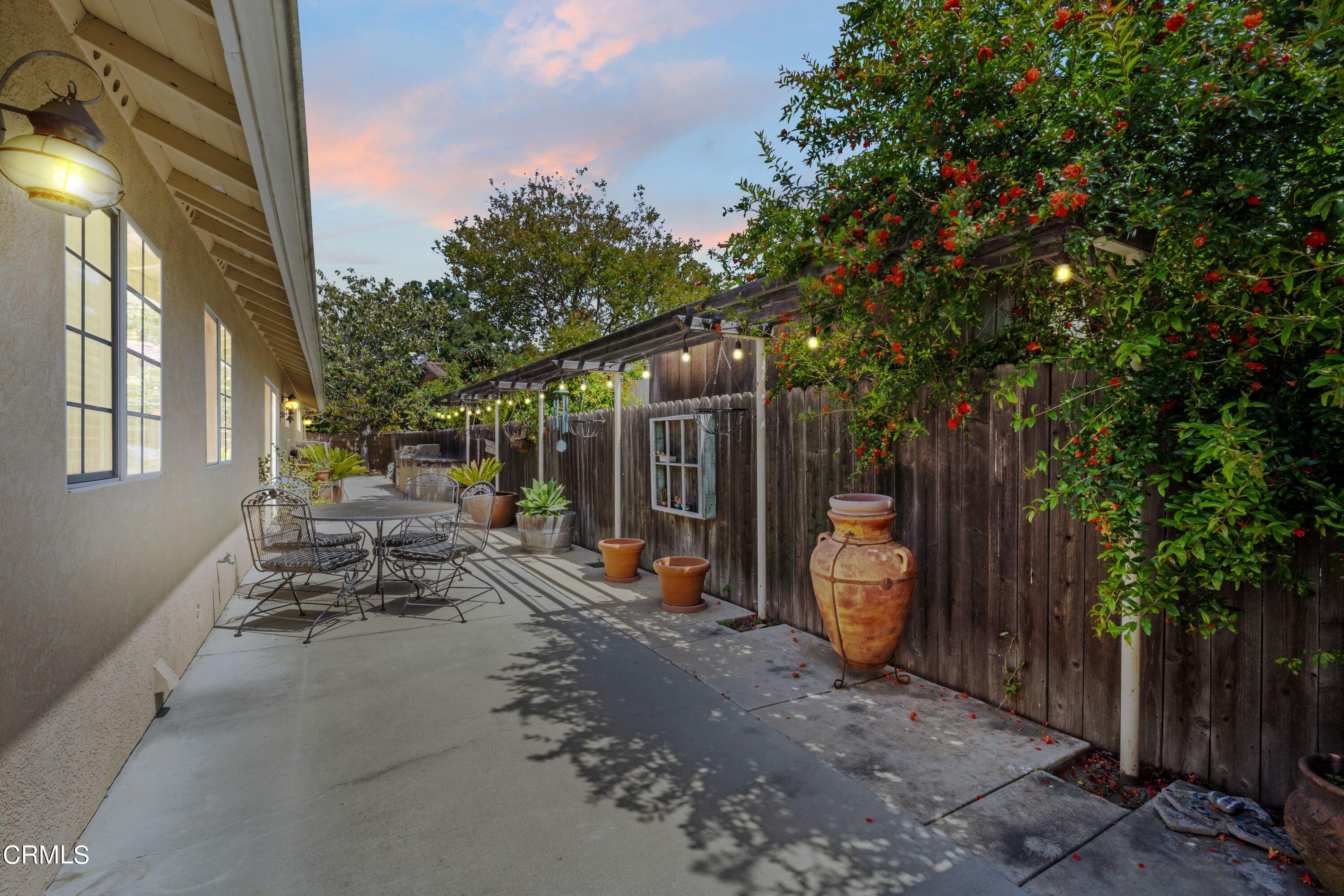 10975 Darling Road Ventura, CA 93004 - Photo 38 of 49 a view of a patio with table and chairs and a large tree