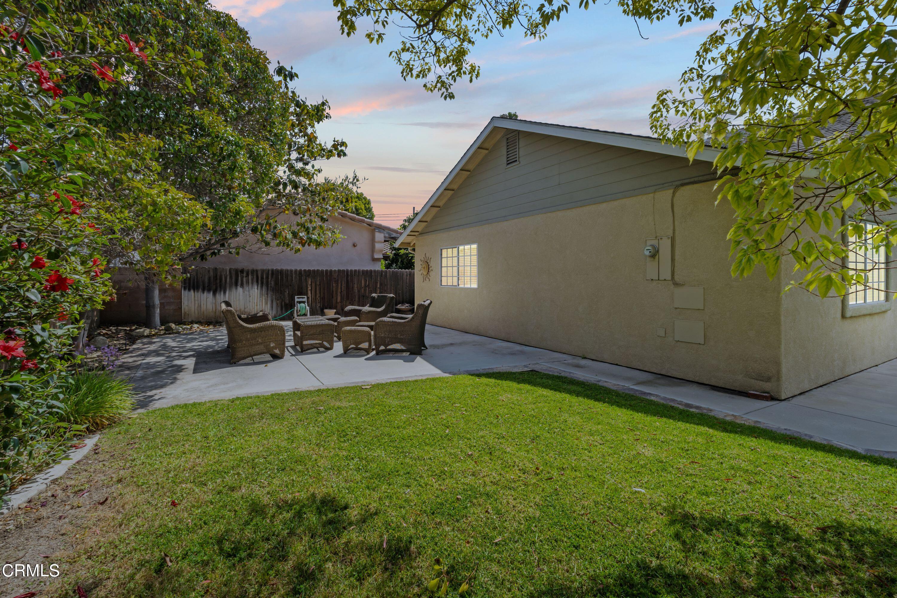 10975 Darling Road Ventura, CA 93004 - Photo 39 of 49 a view of a patio with table and chairs under an umbrella
