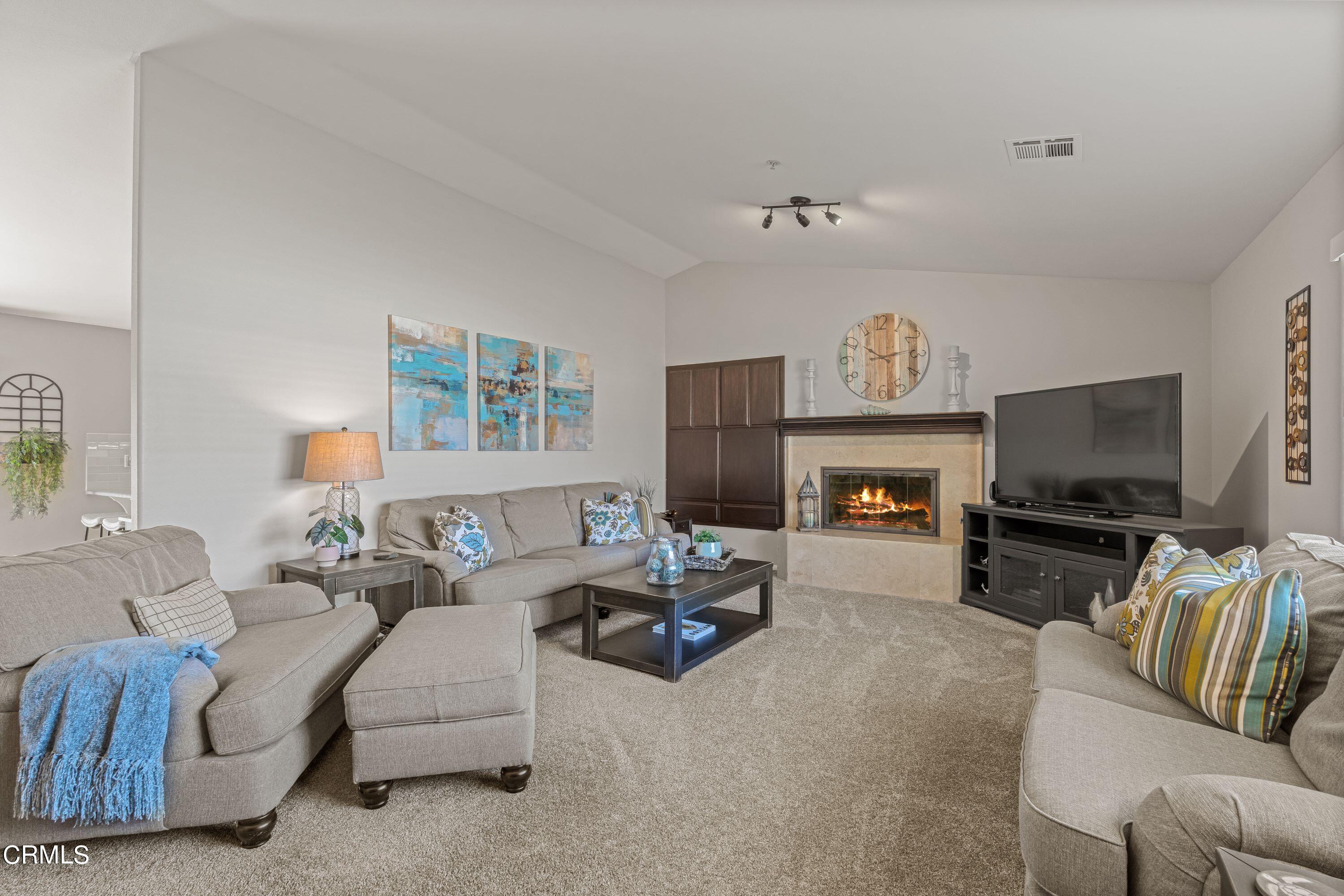 10975 Darling Road Ventura, CA 93004 - Photo 4 of 49 a living room with furniture a flat screen tv and a fireplace