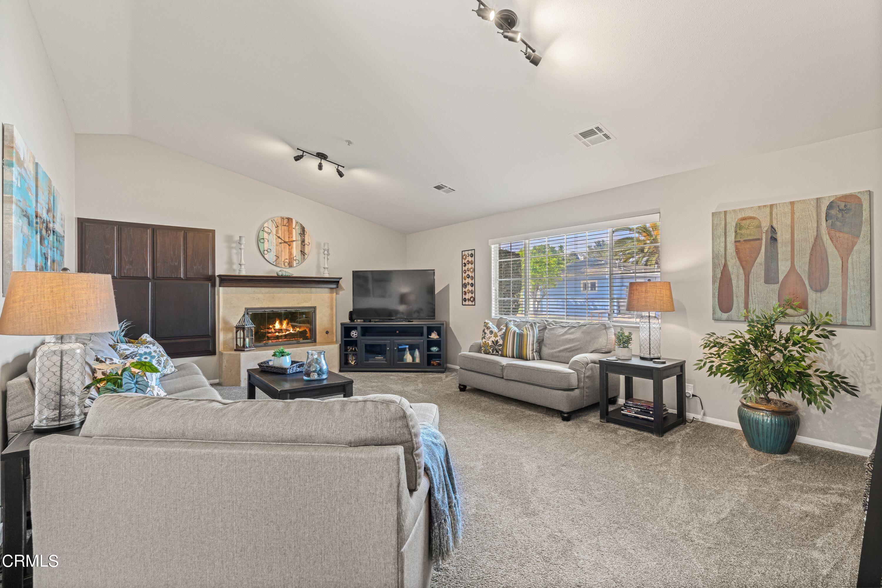 10975 Darling Road Ventura, CA 93004 - Photo 5 of 49 a living room with furniture a fireplace and a potted plant