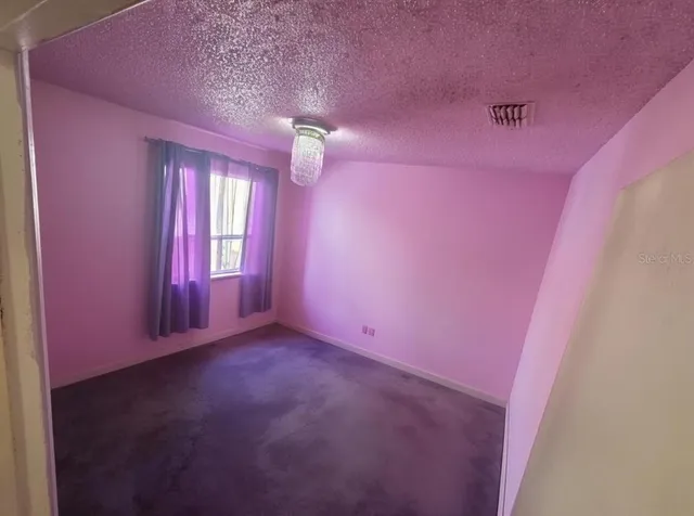 a room with wooden floor and windows