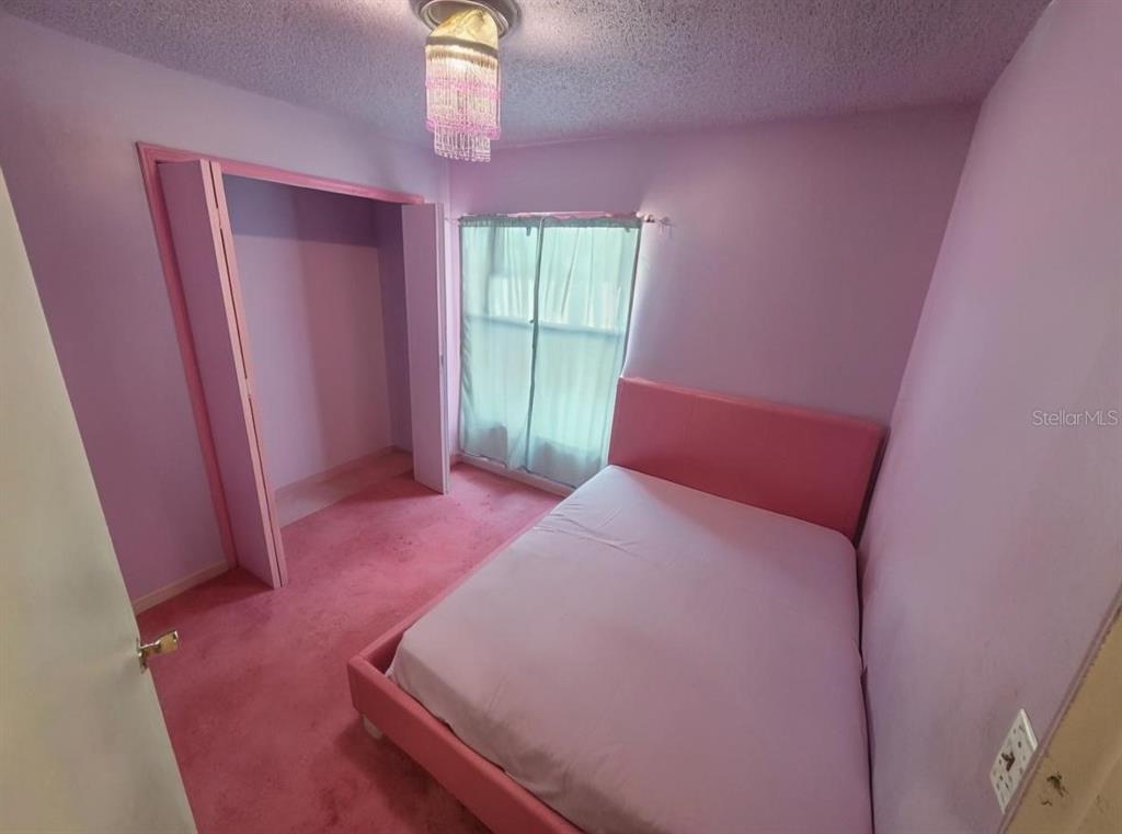 299 Indian Point Circle Kissimmee, FL 34746 - Photo 15 of 24 a room with wooden floor and windows