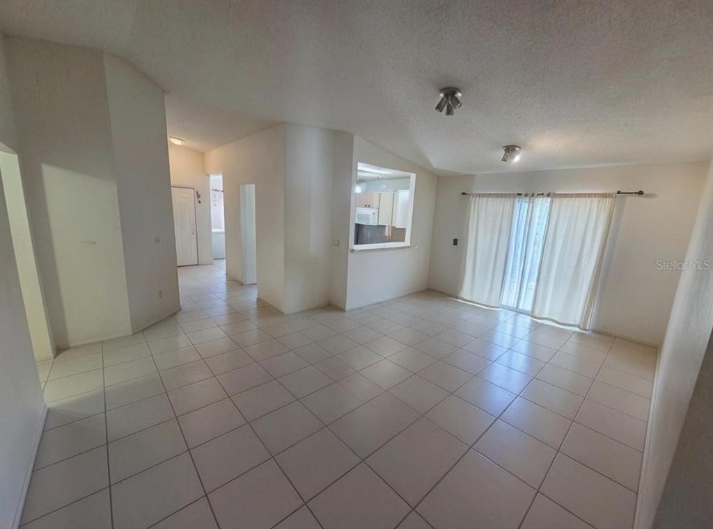 299 Indian Point Circle Kissimmee, FL 34746 - Photo 2 of 24 an empty room & view of a bathroom