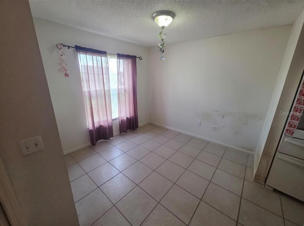 299 Indian Point Circle Kissimmee, FL 34746 - Photo 4 of 24 an empty room with windows
