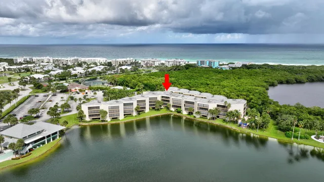 a view of a lake with lawn chairs
