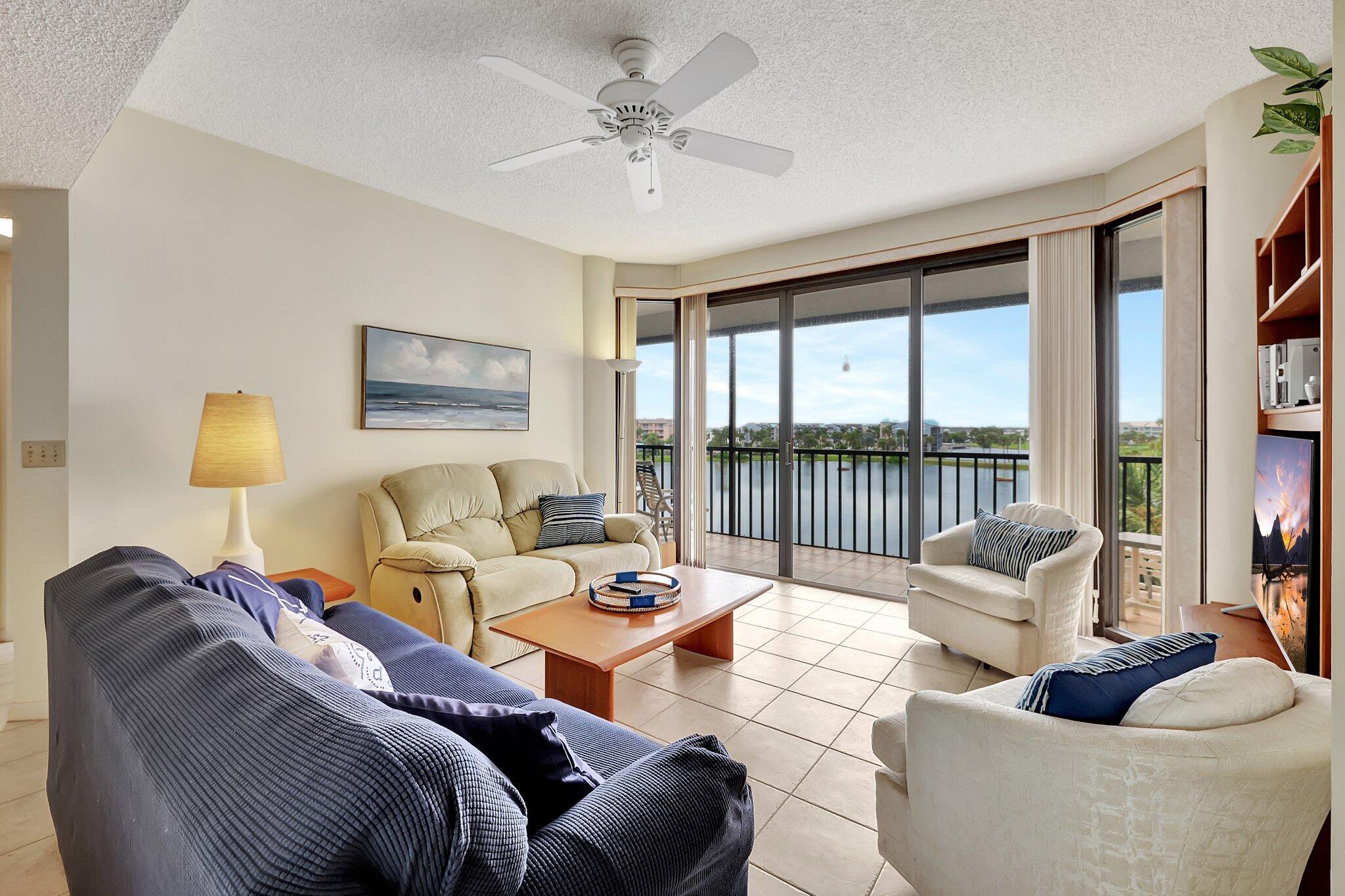 221 Northeast Plantation Road, Unit 406 Stuart, FL 34996 - Photo 12 of 58 a living room with furniture and a large window
