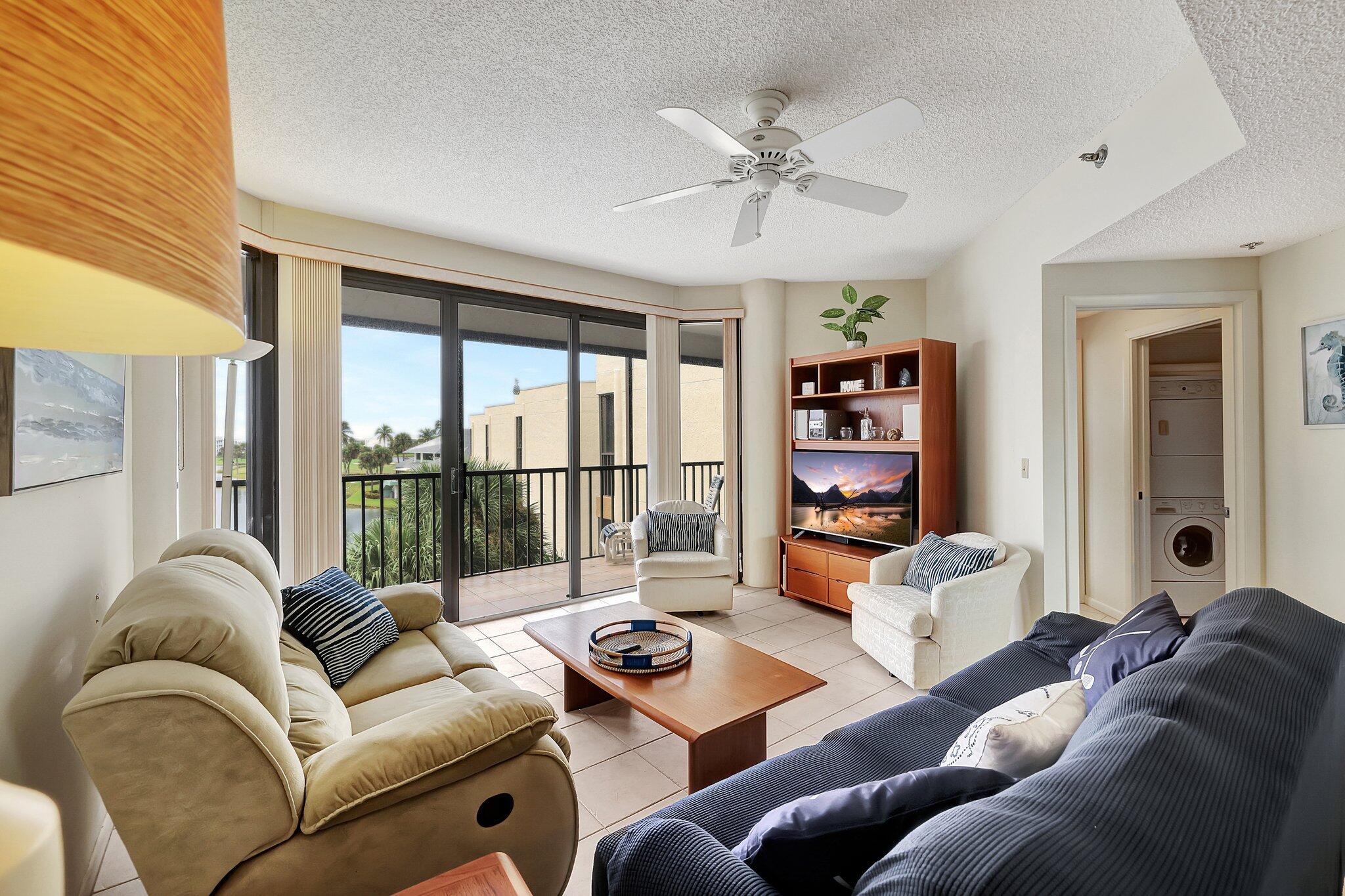 221 Northeast Plantation Road, Unit 406 Stuart, FL 34996 - Photo 14 of 58 a living room with furniture and a large window