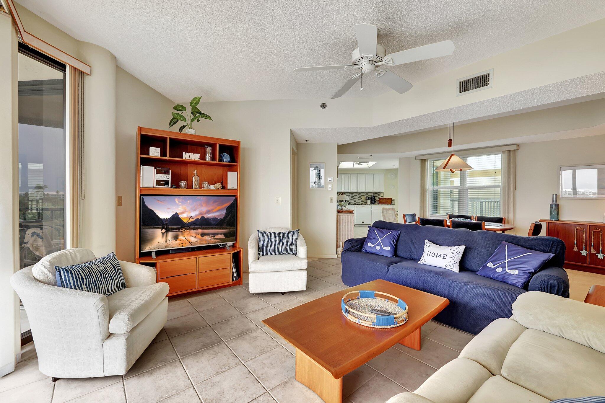 221 Northeast Plantation Road, Unit 406 Stuart, FL 34996 - Photo 15 of 58 a living room with furniture and a wooden floor