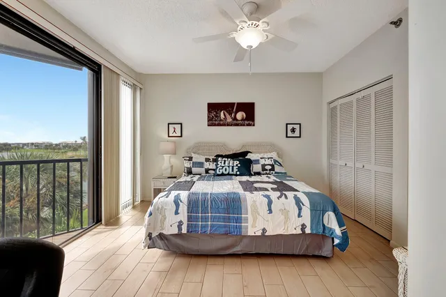 a bedroom with a bed a flat screen tv and a fireplace