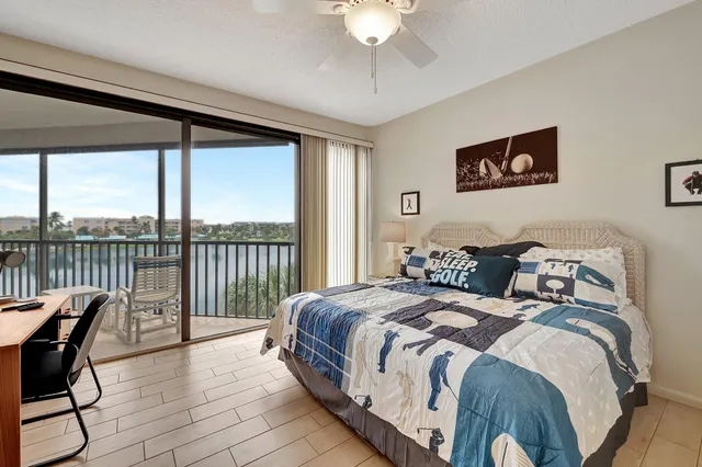 a bed room with a bed and a chair