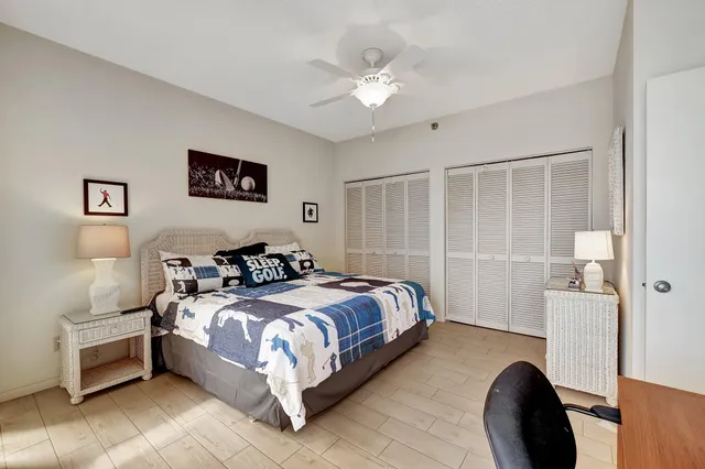 a bathroom with a granite countertop sink a mirror and shower
