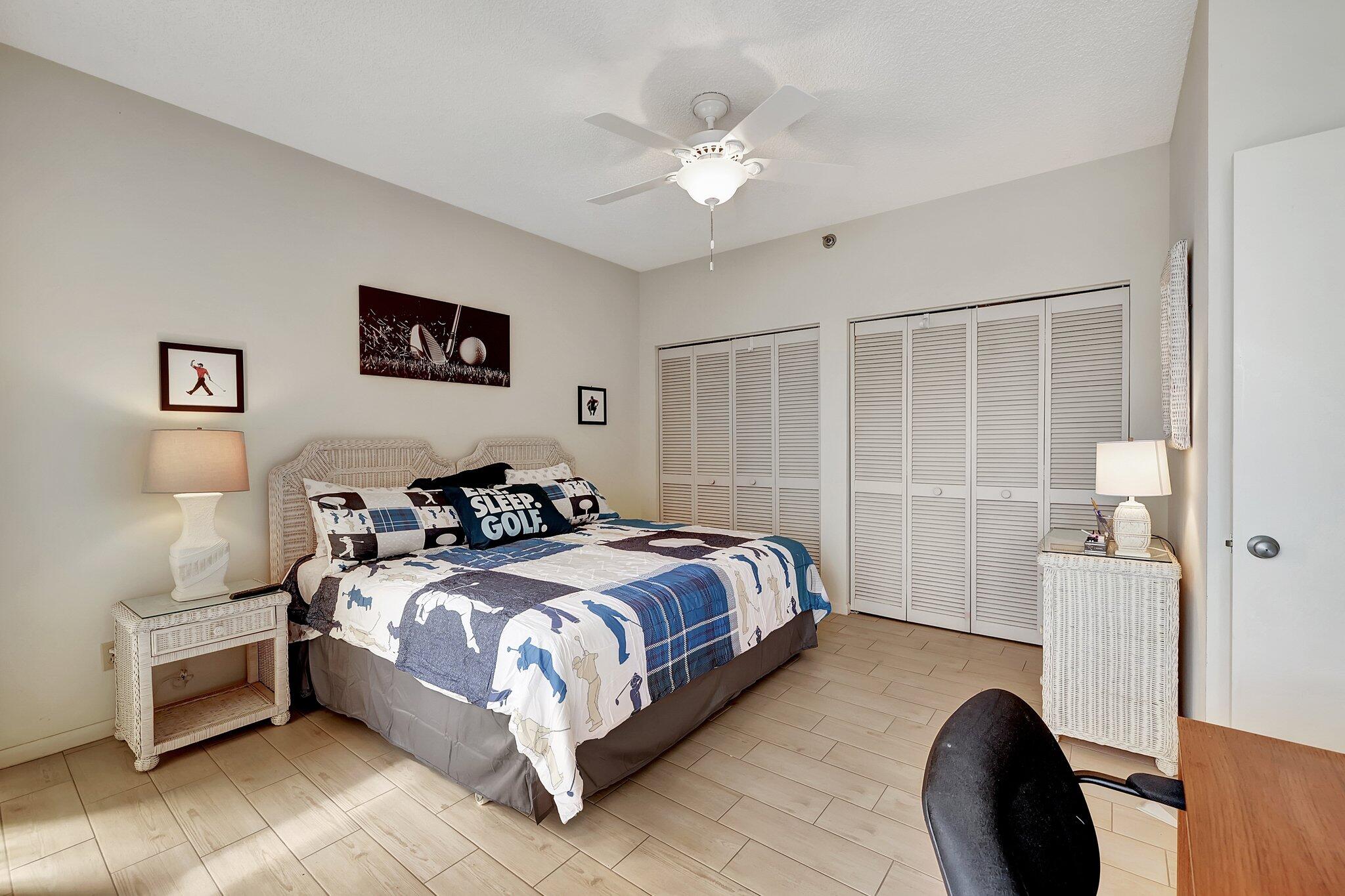 221 Northeast Plantation Road, Unit 406 Stuart, FL 34996 - Photo 20 of 58 a bed room with a bed and a chair