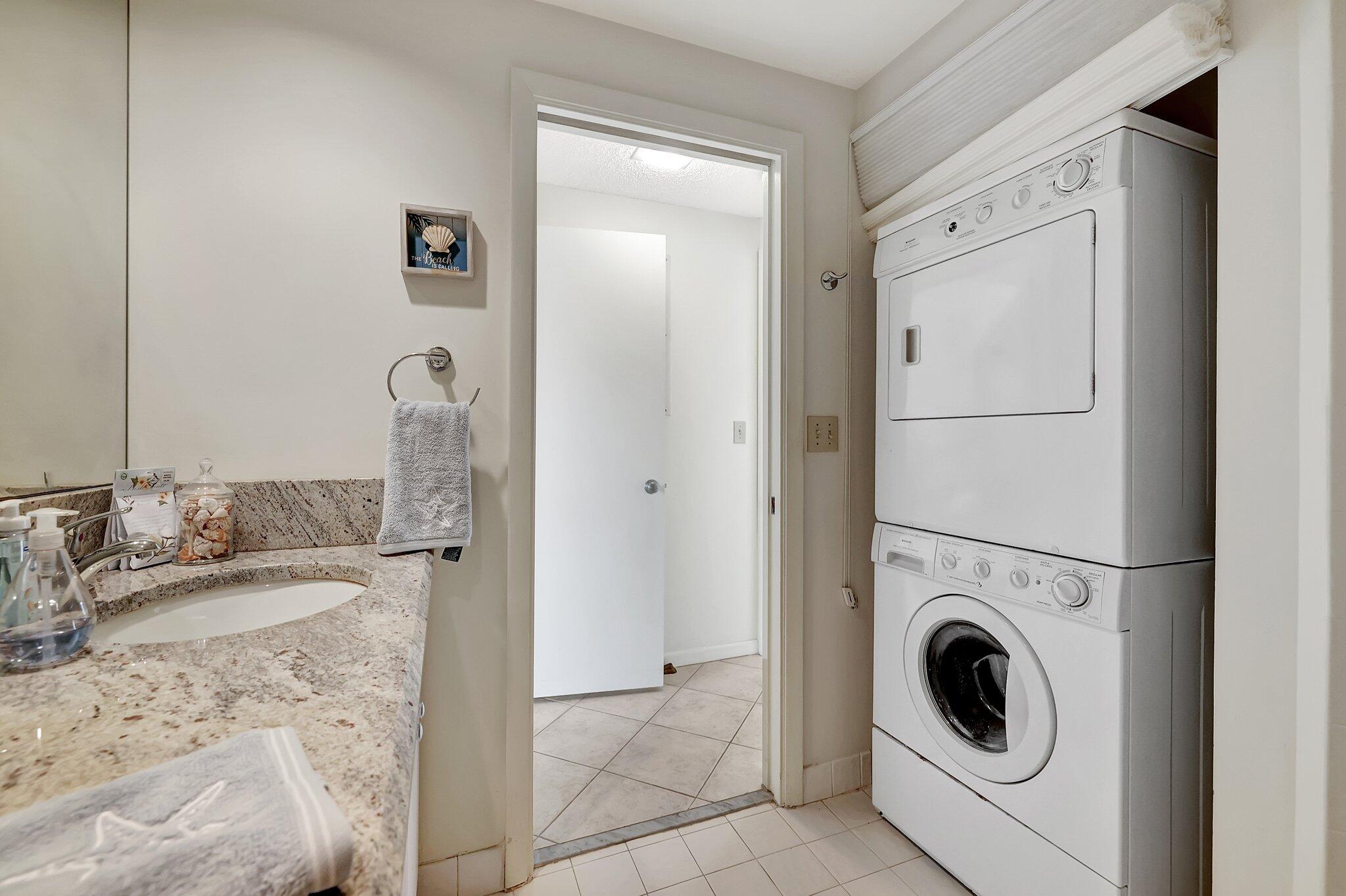 221 Northeast Plantation Road, Unit 406 Stuart, FL 34996 - Photo 23 of 58 a bathroom with a granite countertop sink a mirror and shower
