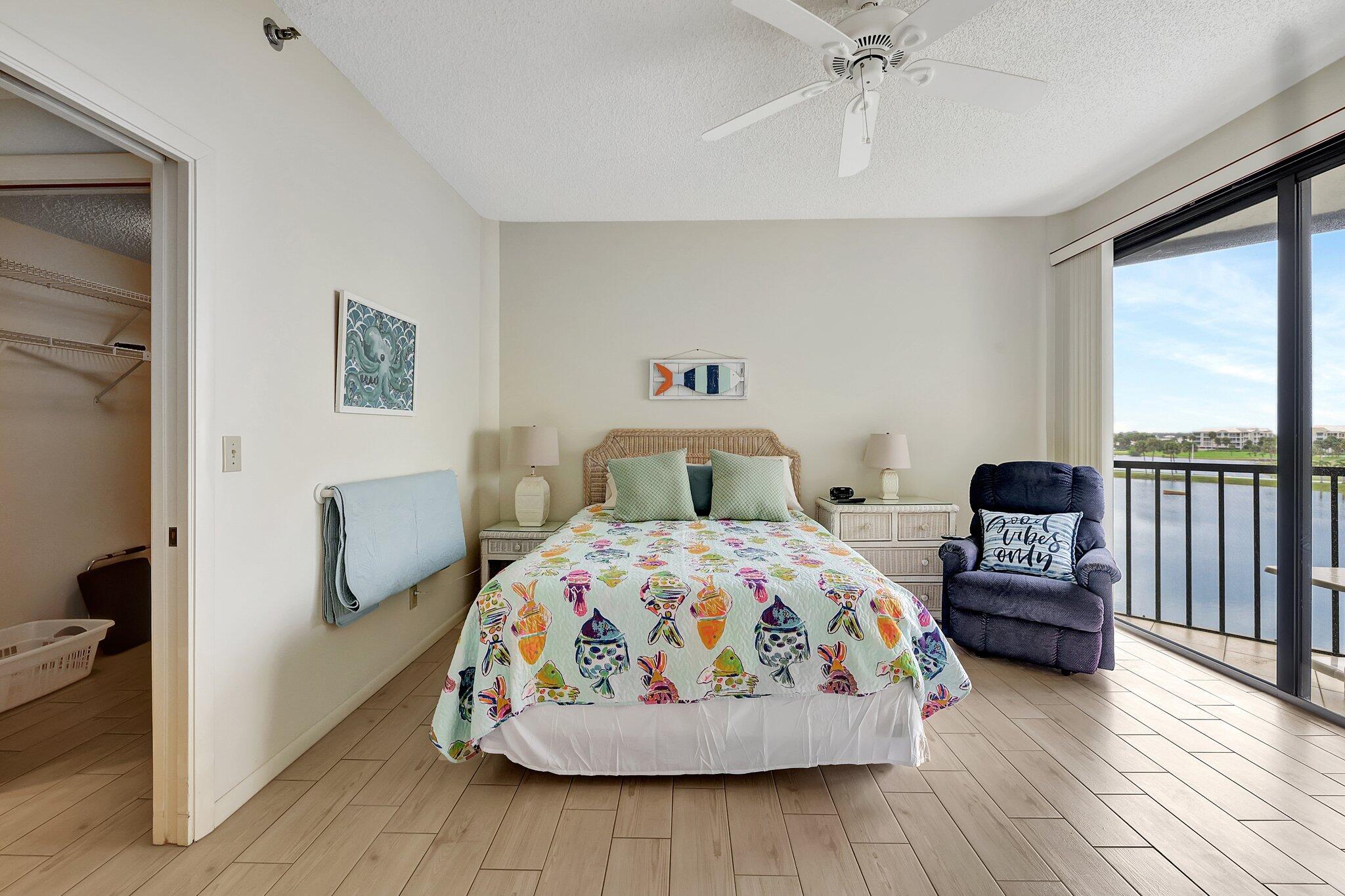 221 Northeast Plantation Road, Unit 406 Stuart, FL 34996 - Photo 24 of 58 a bedroom with a bed and wooden floor