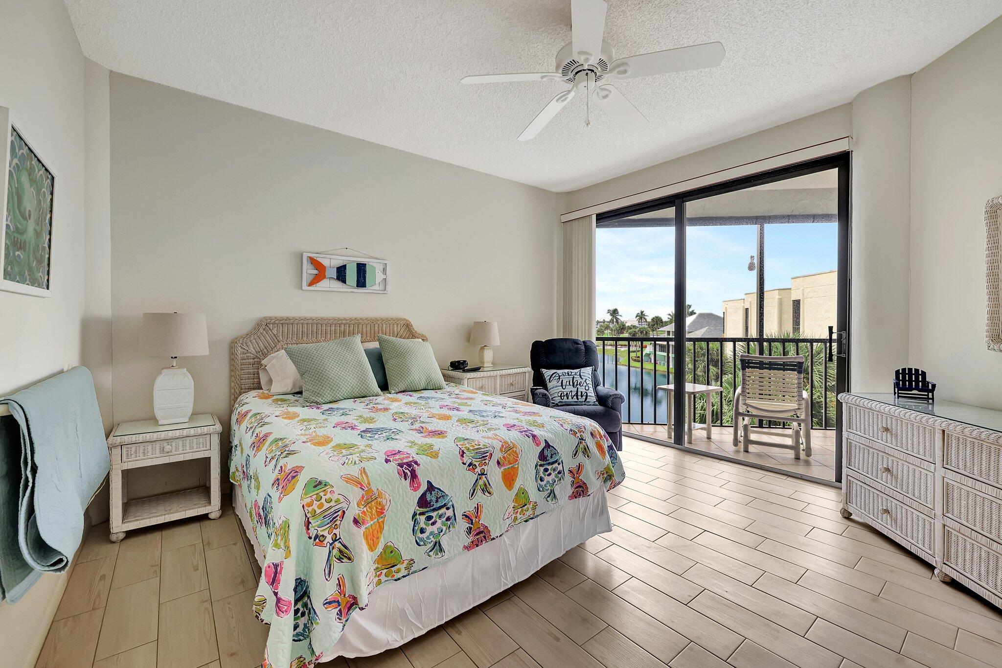 221 Northeast Plantation Road, Unit 406 Stuart, FL 34996 - Photo 25 of 58 a bedroom with a bed and a view of balcony