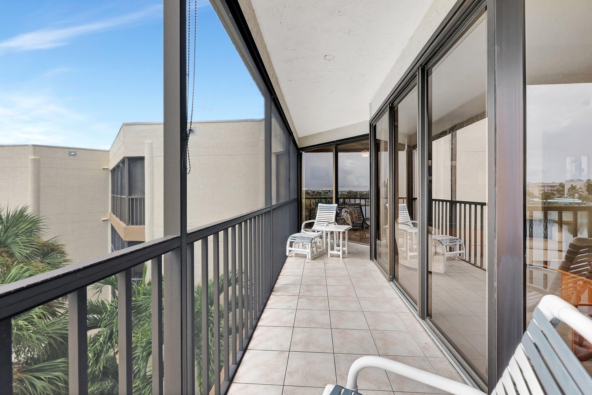 221 Northeast Plantation Road, Unit 406 Stuart, FL 34996 - Photo 32 of 58 a view of balcony with wooden floor and door